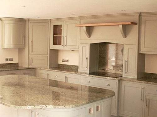 Oak and tulip wood units, large central island, floor to ceiling units houses the Aga, marble worktops